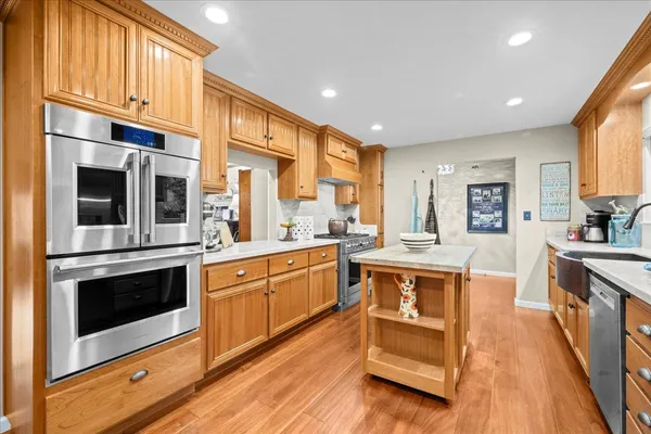 a large kitchen with stainless steel appliances granite countertop a stove and a sink