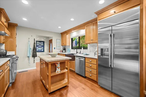 a kitchen with a stove a refrigerator and a sink