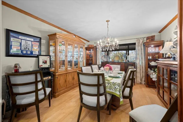 a view of a dining room with furniture and chandelier