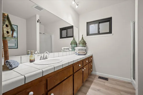 a bathroom with double vanity sinks and a mirror