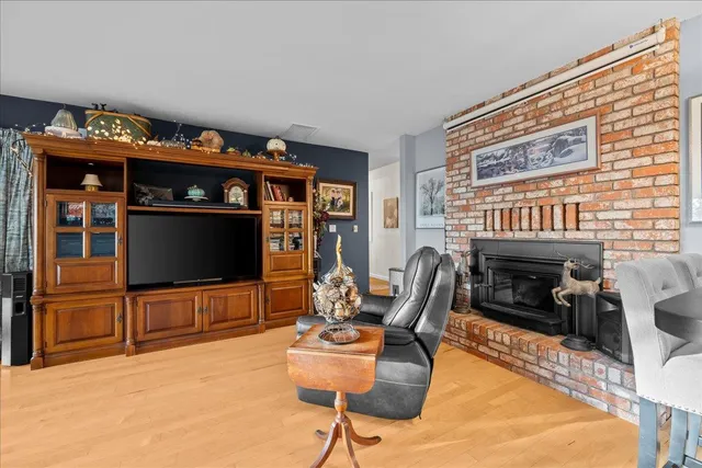 a living room with furniture a rug and a flat screen tv