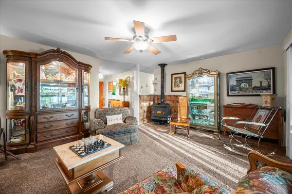 a living room with furniture a rug and a flat screen tv