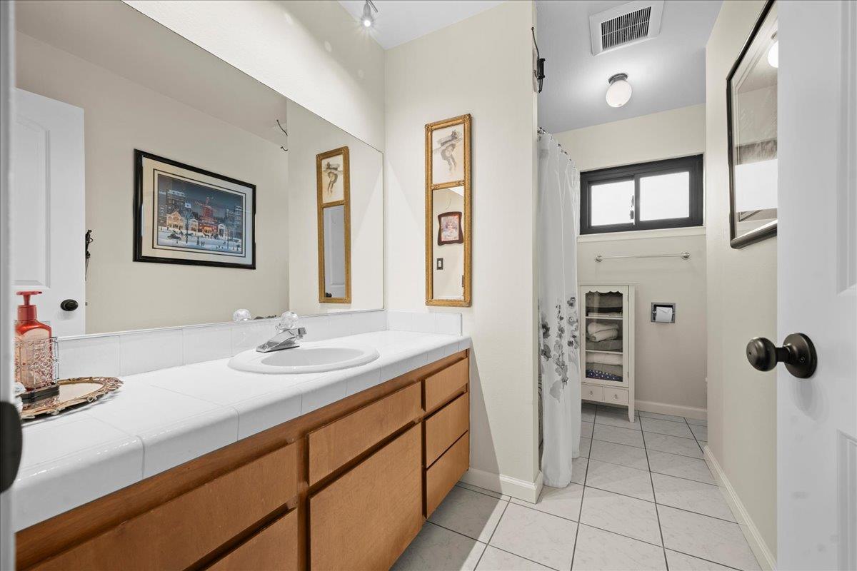 3900 Loma Drive Shingle Springs, CA 95682 - Photo 36 of 55 a bathroom with a sink and a mirror