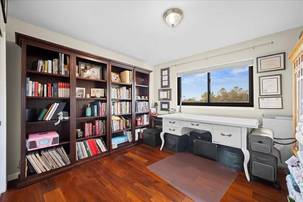 a living room with furniture and a book shelf