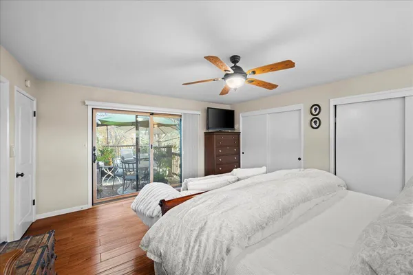 a bedroom with a bed and wooden floor