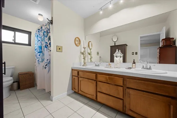 a bathroom with a double vanity sink and a mirror