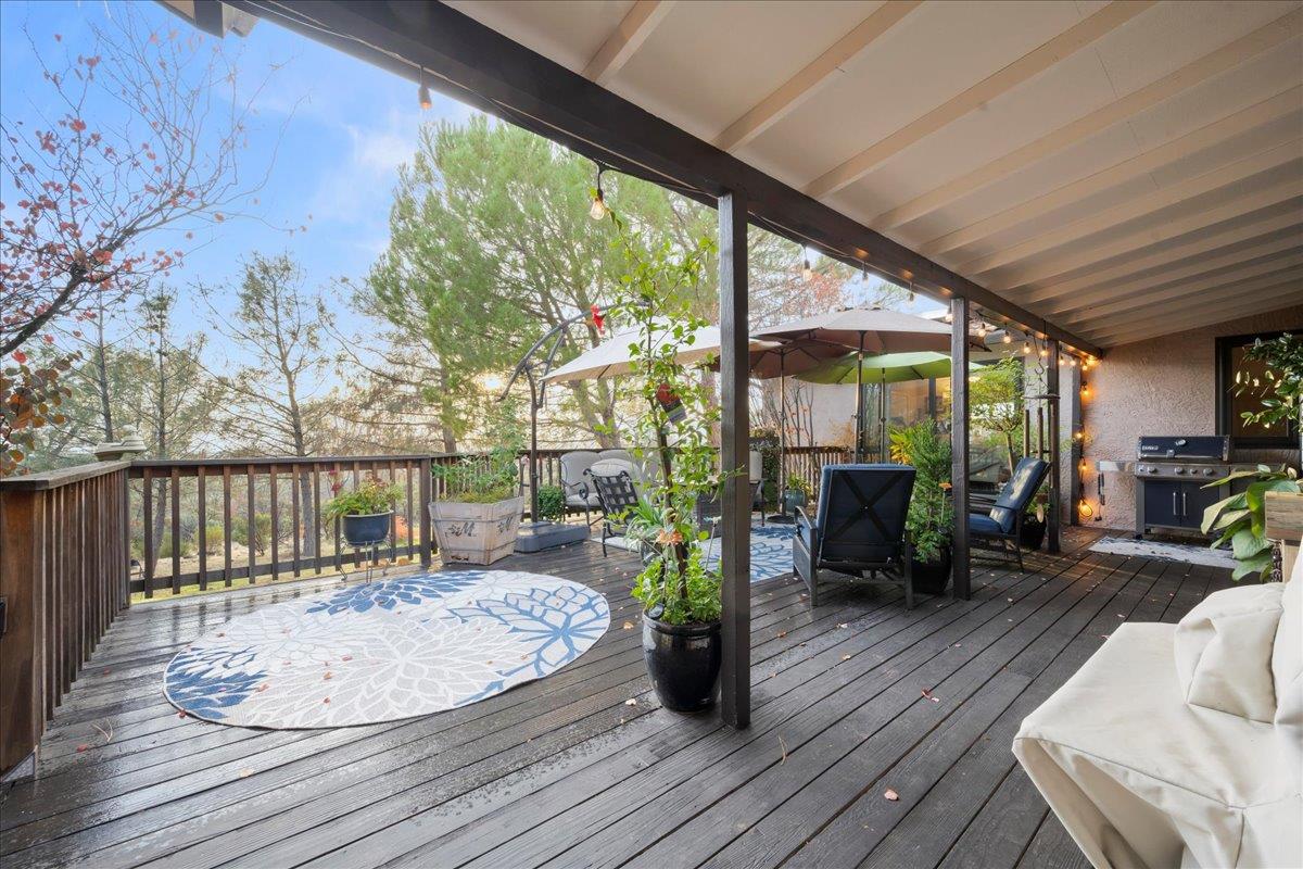 3900 Loma Drive Shingle Springs, CA 95682 - Photo 43 of 55 a view of a patio with a table chairs and wooden floor