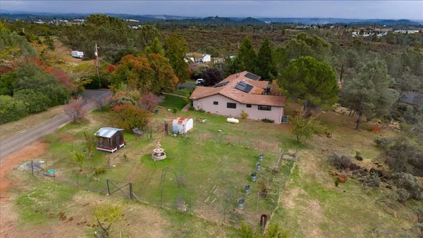 an aerial view of a house with a yard