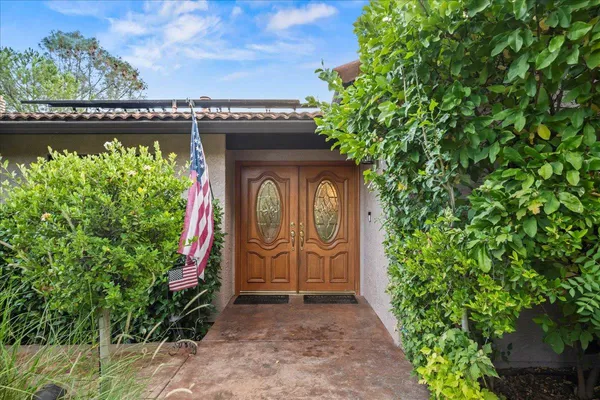 a front view of a house with lots of green space