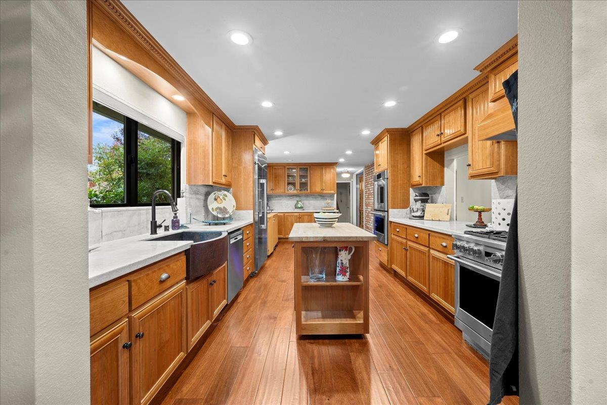 3900 Loma Drive Shingle Springs, CA 95682 - Photo 9 of 55 a kitchen with stainless steel appliances granite countertop sink stove top oven and cabinets