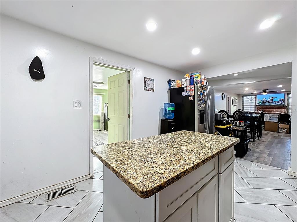 7717 Clarcona Ocoee Road, Unit LOT 1 Orlando, FL 32818 - Photo 14 of 36 a kitchen with sink and refrigerator