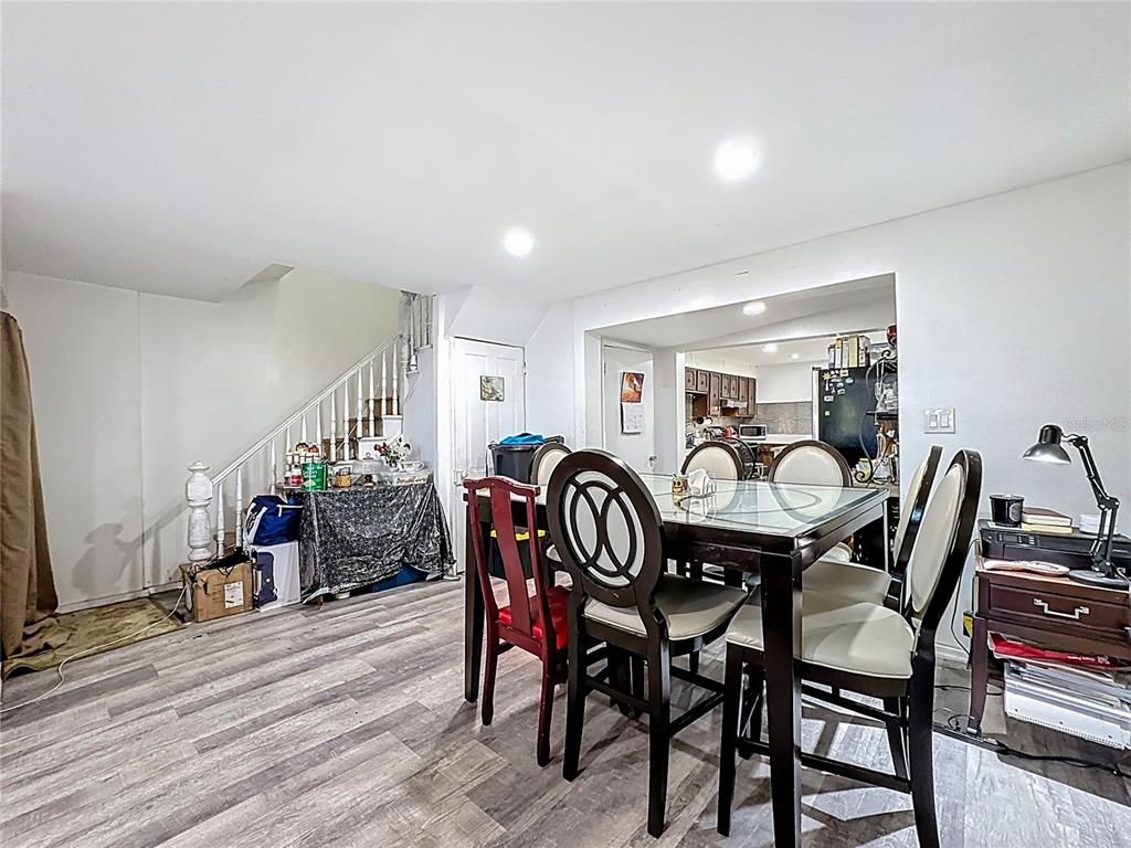7717 Clarcona Ocoee Road, Unit LOT 1 Orlando, FL 32818 - Photo 17 of 36 a view of a dining room with furniture and wooden floor