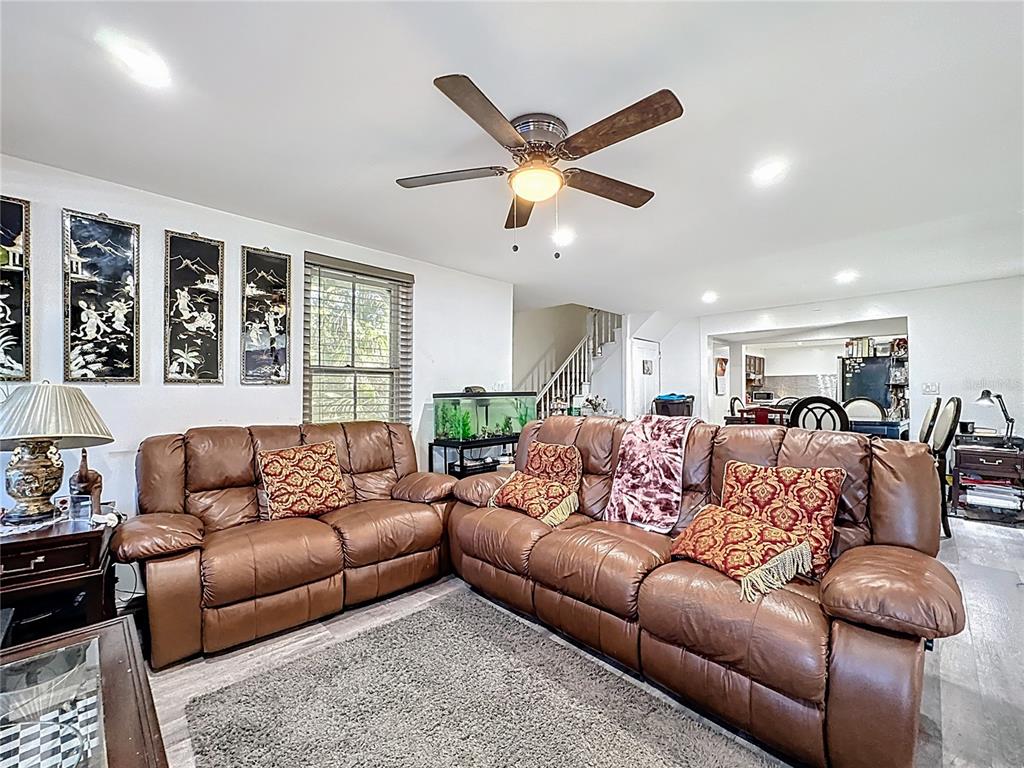 7717 Clarcona Ocoee Road, Unit LOT 1 Orlando, FL 32818 - Photo 19 of 36 a living room with furniture ceiling fan and a window