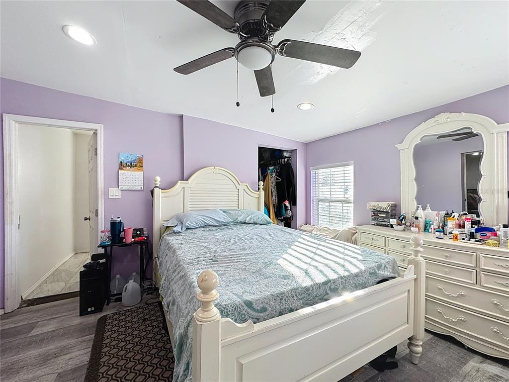 7717 Clarcona Ocoee Road, Unit LOT 1 Orlando, FL 32818 - Photo 24 of 36 a bedroom with a bed and a dresser