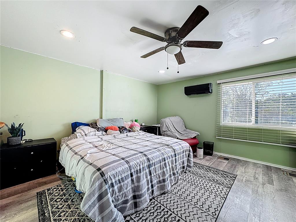 7717 Clarcona Ocoee Road, Unit LOT 1 Orlando, FL 32818 - Photo 31 of 36 a bedroom with a bed and a chandelier
