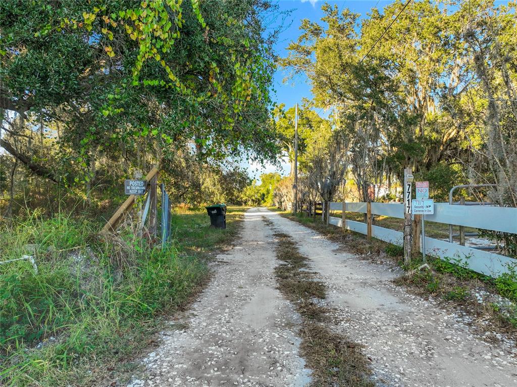 7717 Clarcona Ocoee Road, Unit LOT 1 Orlando, FL 32818 - Photo 4 of 36 a view of road with large trees