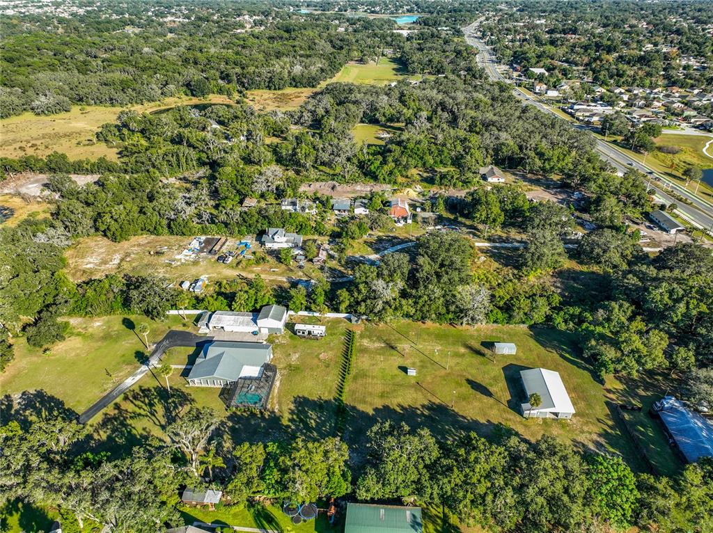 7717 Clarcona Ocoee Road, Unit LOT 1 Orlando, FL 32818 - Photo 9 of 36 an aerial view of residential house with outdoor space and trees all around