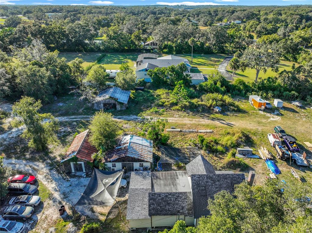 7717 Clarcona Ocoee Road, Unit LOT 1 Orlando, FL 32818 - Photo 10 of 36 an aerial view of residential house with outdoor space and lake view