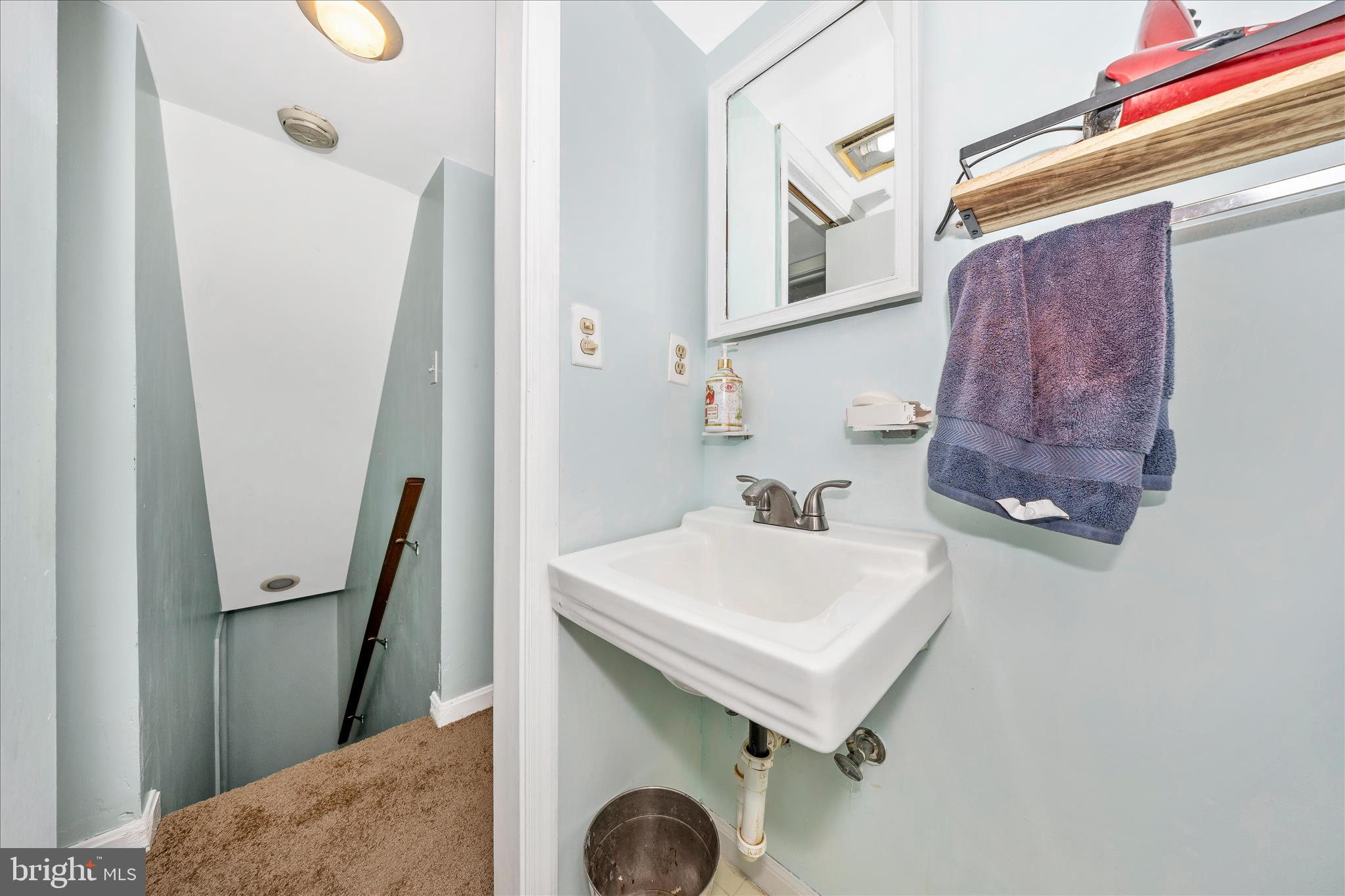 5618 Bartonsville Road Frederick, MD 21704 - Photo 34 of 53 a bathroom with a sink a mirror and a toilet