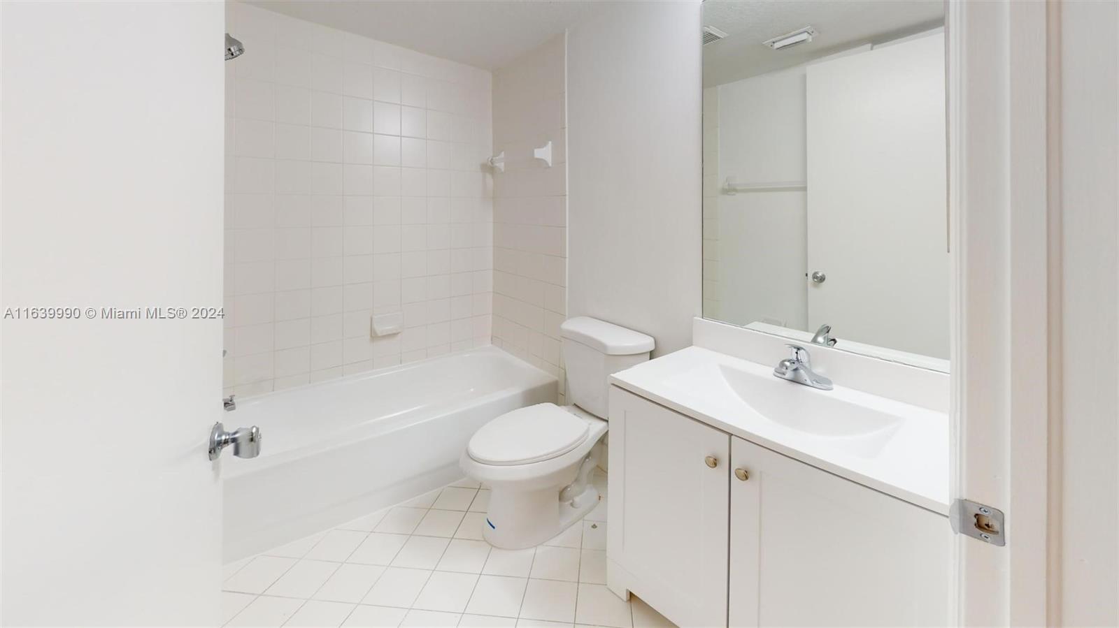 2921 Southeast 13th Road, Unit 10539 Homestead, FL 33035 - Photo 12 of 14 a bathroom with a sink a toilet and shower