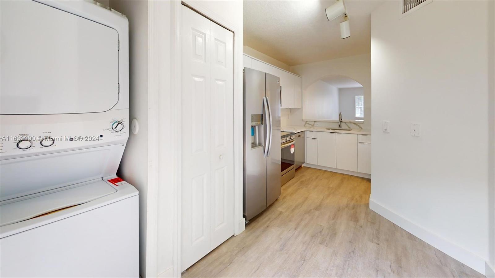 2921 Southeast 13th Road, Unit 10539 Homestead, FL 33035 - Photo 3 of 14 a view of a kitchen with refrigerator and wooden floor