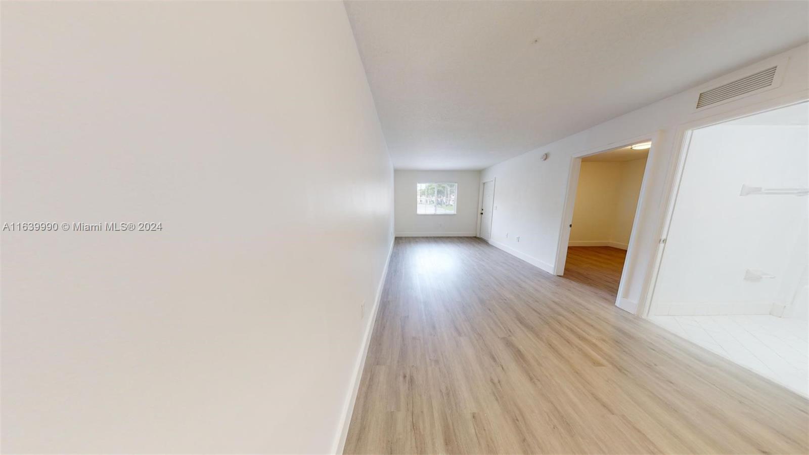 2921 Southeast 13th Road, Unit 10539 Homestead, FL 33035 - Photo 5 of 14 a view of a room with wooden floor and a window