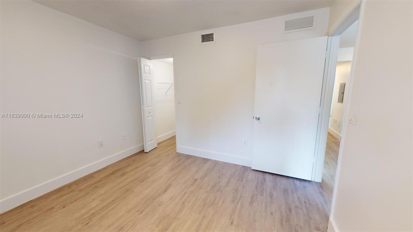 2921 Southeast 13th Road, Unit 10539 Homestead, FL 33035 - Photo 8 of 14 a view of an empty room with wooden floor
