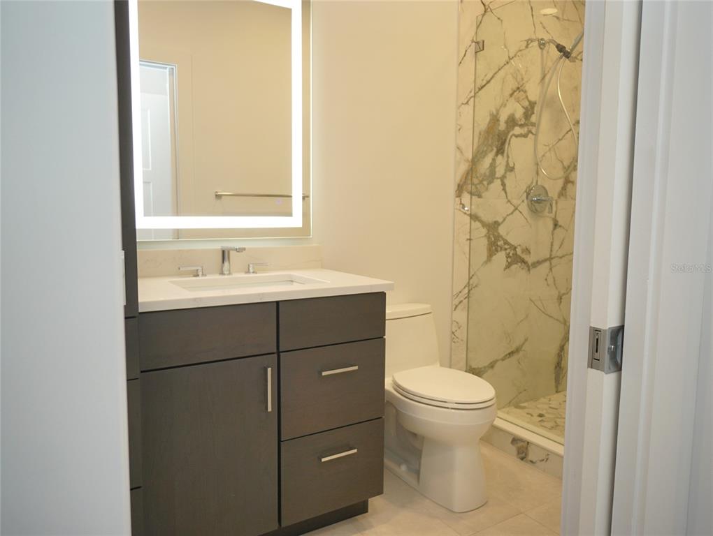 5000 Culbreath Key Way, Unit 9326 Tampa, FL 33611 - Photo 18 of 35 a bathroom with a sink and a toilet