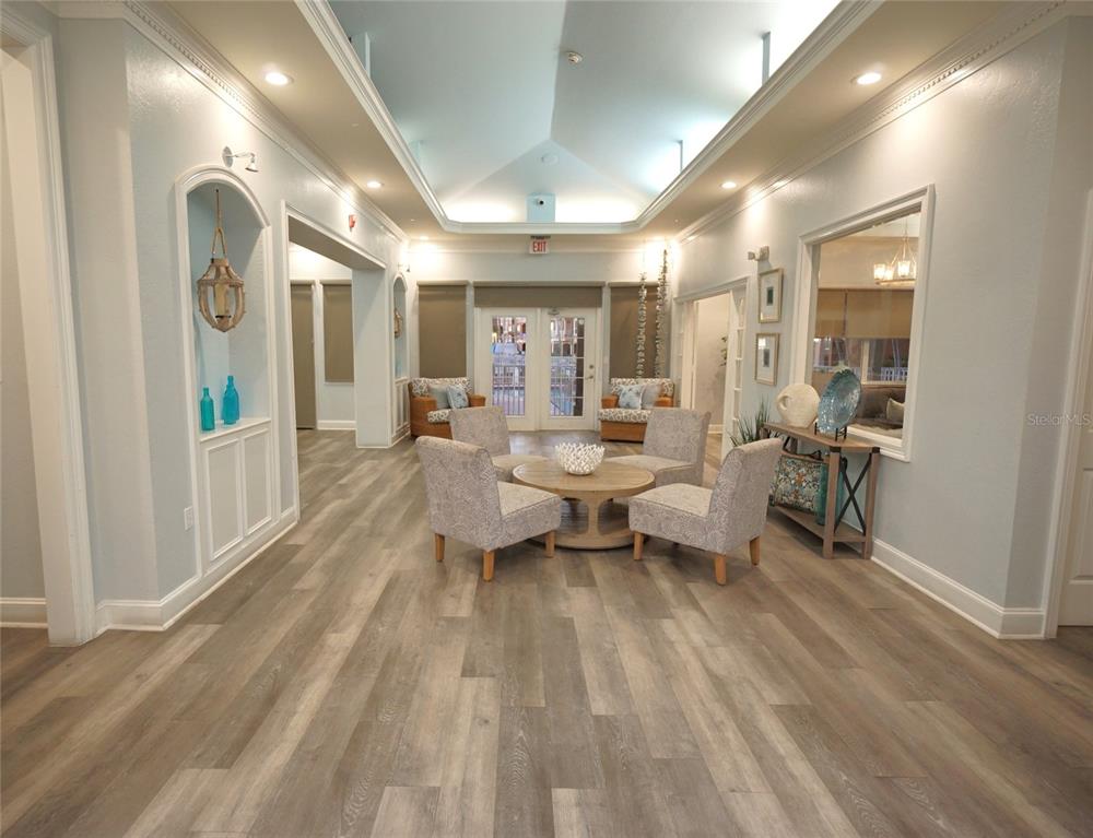 5000 Culbreath Key Way, Unit 9326 Tampa, FL 33611 - Photo 29 of 35 a living room with furniture and a wooden floor