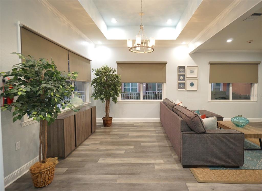 5000 Culbreath Key Way, Unit 9326 Tampa, FL 33611 - Photo 33 of 35 a living room with furniture and a chandelier