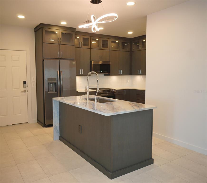 5000 Culbreath Key Way, Unit 9326 Tampa, FL 33611 - Photo 5 of 35 a bathroom with a sink a vanity and a mirror