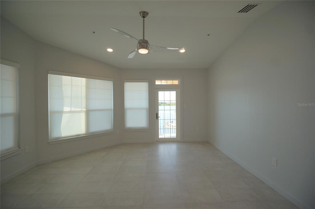 5000 Culbreath Key Way, Unit 9326 Tampa, FL 33611 - Photo 7 of 35 an empty room with windows and chandelier fan