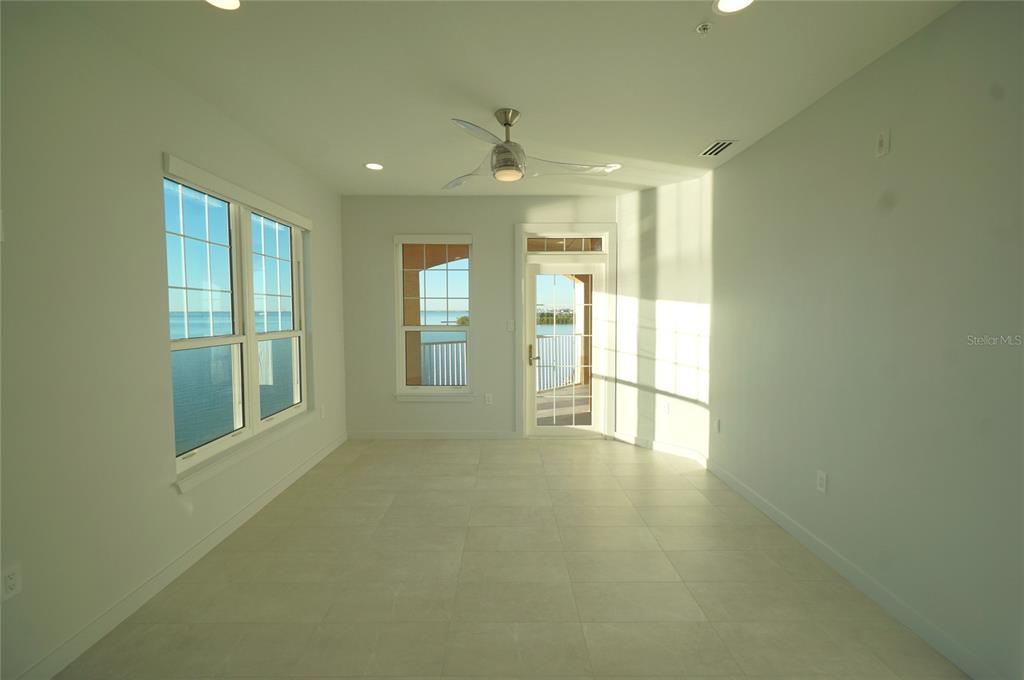 5000 Culbreath Key Way, Unit 9326 Tampa, FL 33611 - Photo 9 of 35 a view of an empty room with glass door and windows