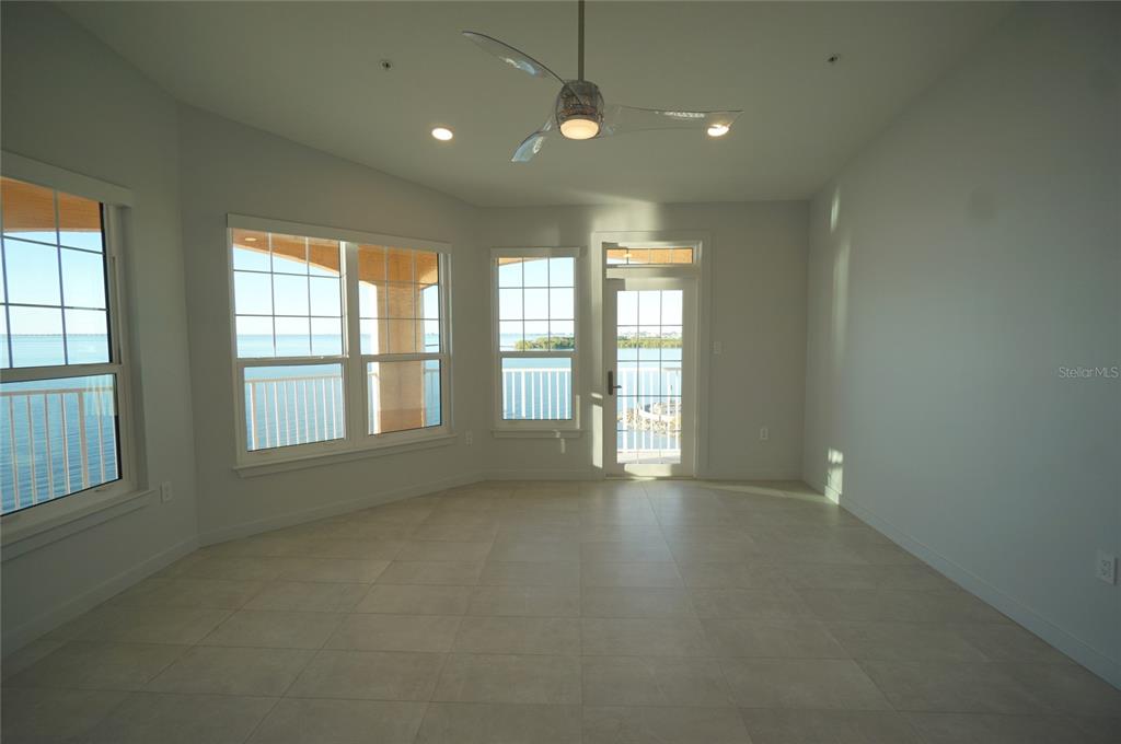 5000 Culbreath Key Way, Unit 9326 Tampa, FL 33611 - Photo 10 of 35 an empty room with windows and chandelier
