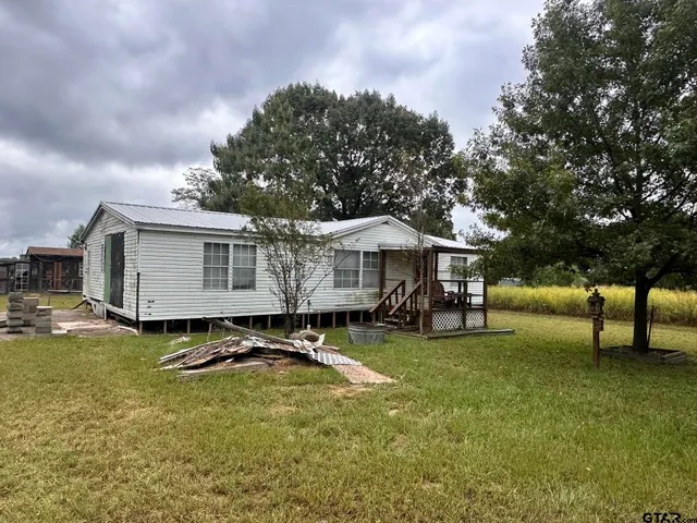 a view of a house with swimming pool and sitting area