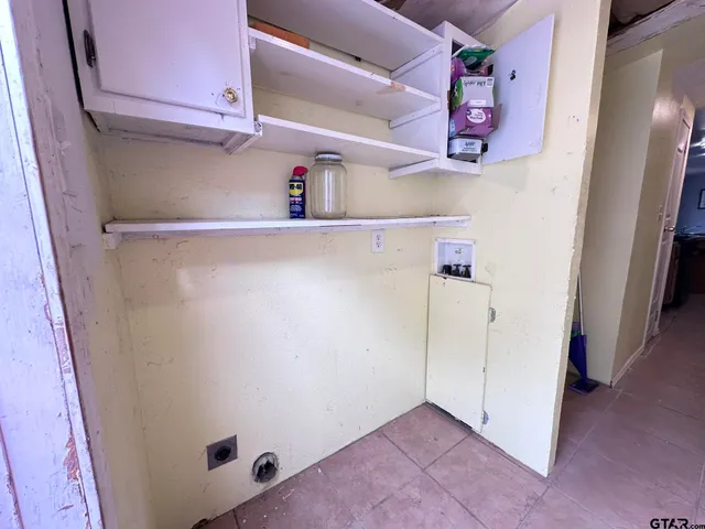 a view of storage and utility room with racks on the wall