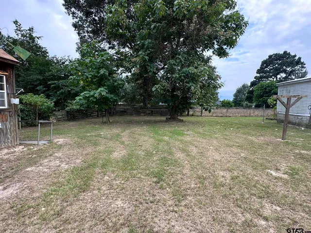 a view of outdoor space with deck and yard