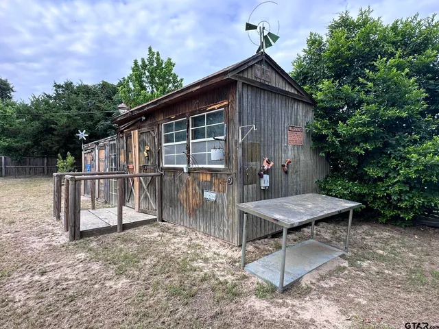 a backyard of a house with table and chairs