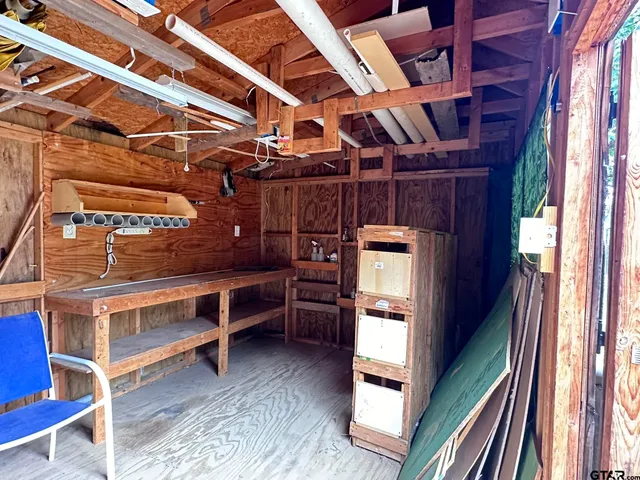 a view of an empty room with furniture and a window