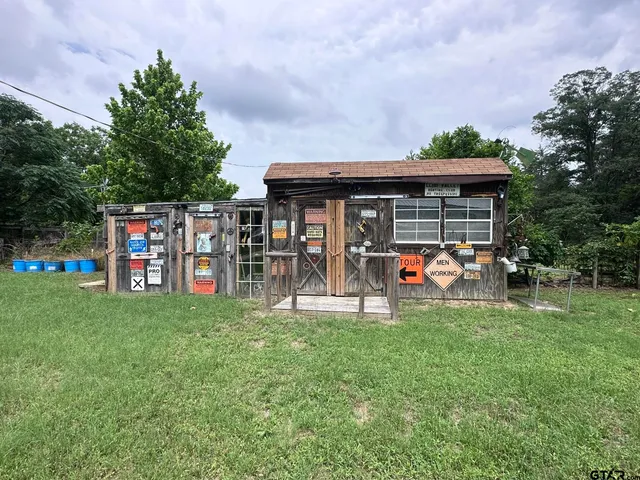 a view of a house with a yard and sitting area