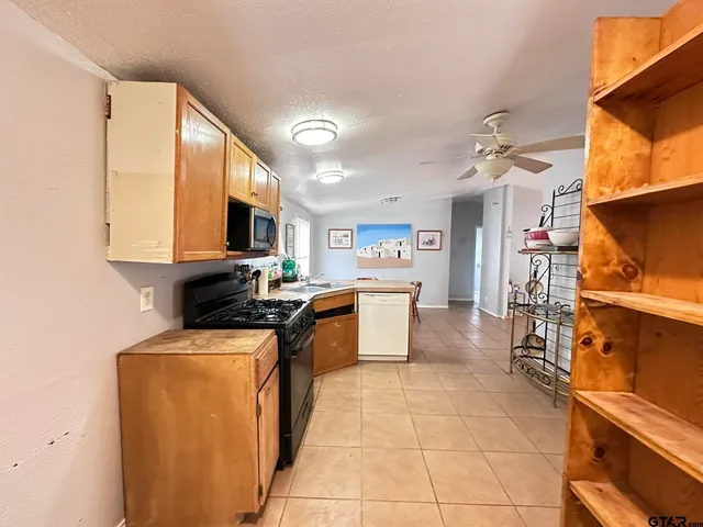 a kitchen with a sink appliances and cabinets