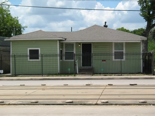 a view of a house with a small yard