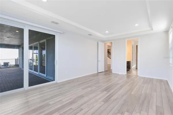a view of empty room with wooden floor