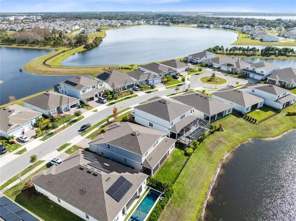 an aerial view of a city with lake view