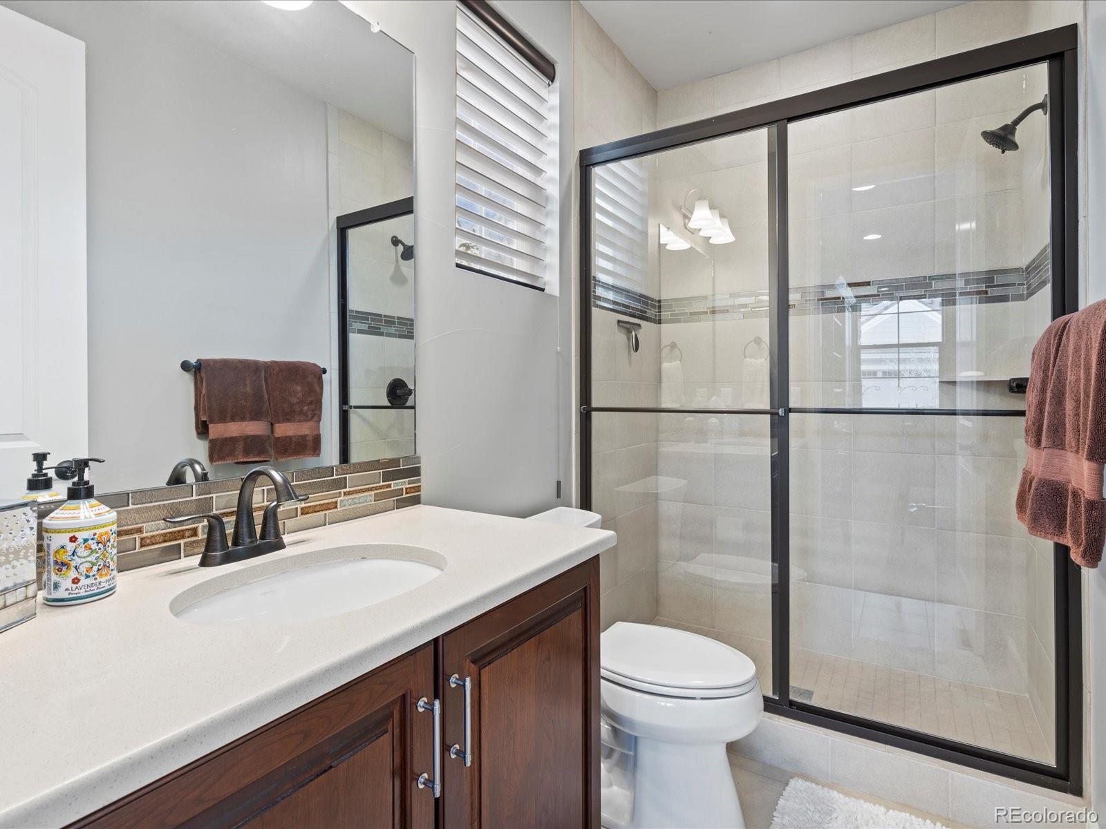 10553 Fairhurst Way Highlands Ranch, CO 80126 - Photo 11 of 35 a bathroom with a sink a toilet and shower