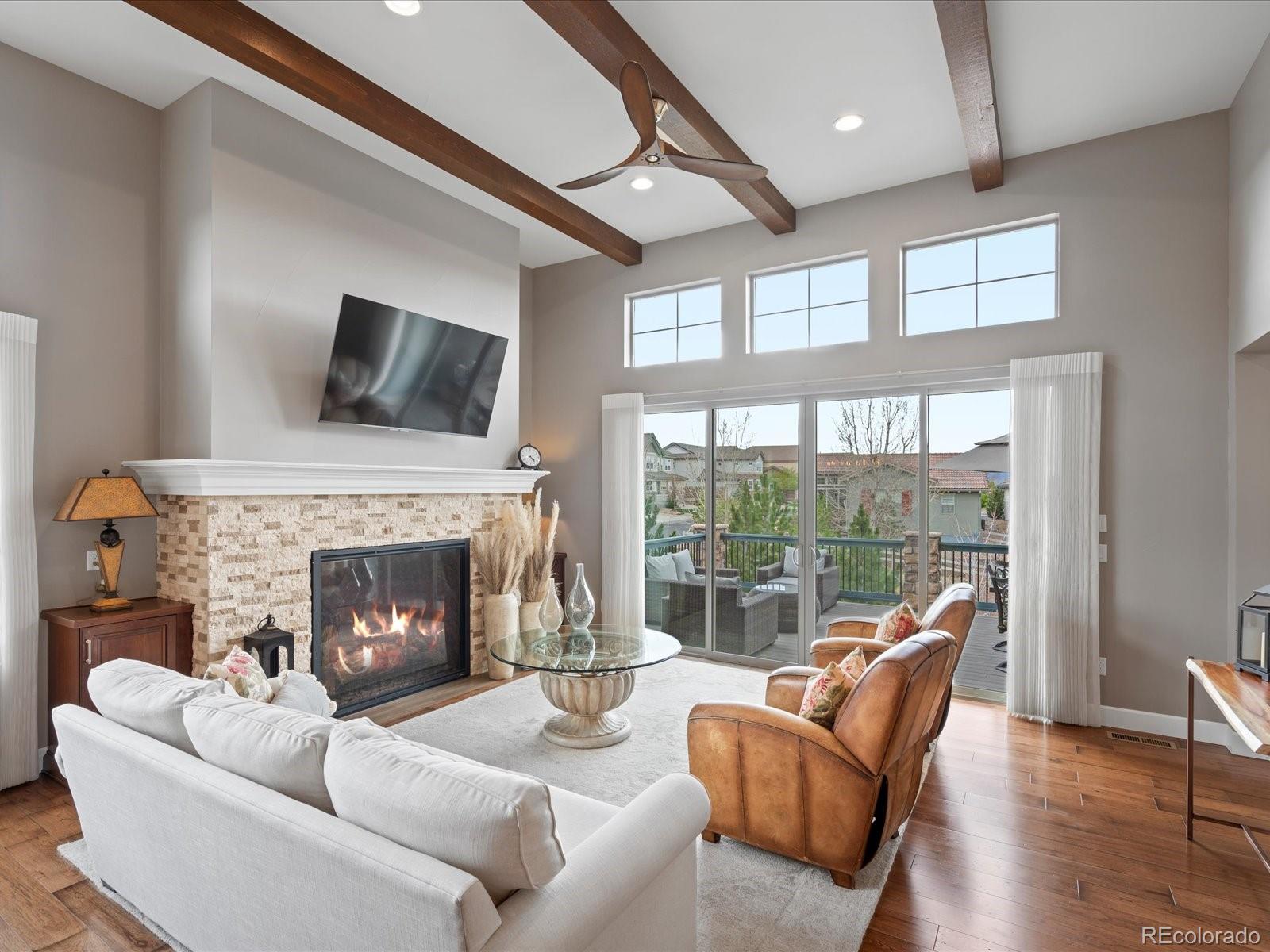 10553 Fairhurst Way Highlands Ranch, CO 80126 - Photo 15 of 35 a living room with furniture a fireplace and a large window