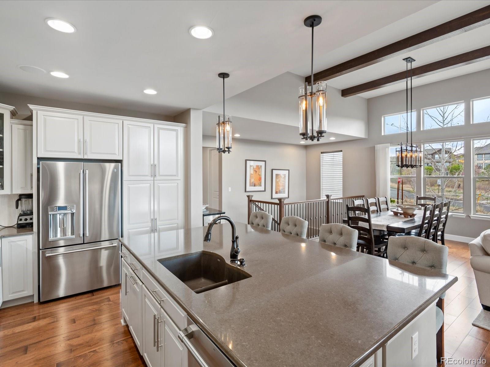 10553 Fairhurst Way Highlands Ranch, CO 80126 - Photo 17 of 35 a kitchen with stainless steel appliances granite countertop a sink a stove and refrigerator