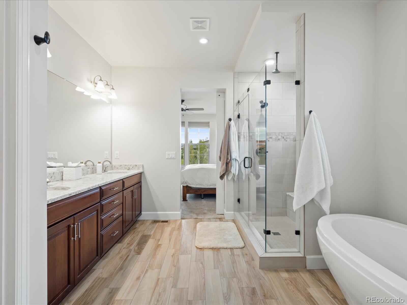 10553 Fairhurst Way Highlands Ranch, CO 80126 - Photo 22 of 35 a bathroom with a tub sink toilet and shower
