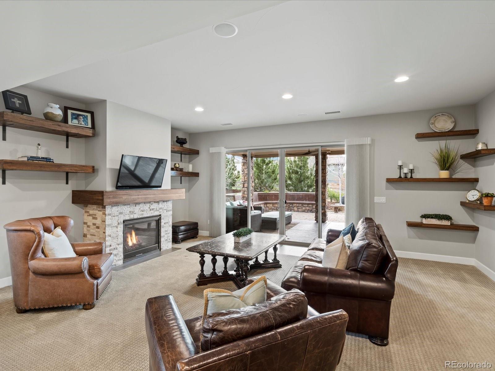 10553 Fairhurst Way Highlands Ranch, CO 80126 - Photo 26 of 35 a living room with furniture and a fireplace