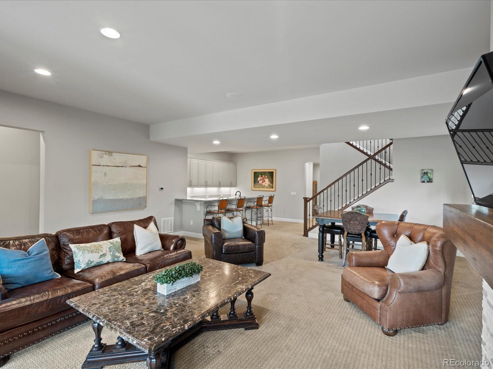 10553 Fairhurst Way Highlands Ranch, CO 80126 - Photo 27 of 35 a living room with furniture and kitchen view